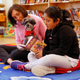 Aelane Vasquez, age nine, reads with Leslie Hight, a therapy dog handler for New York Therapy Animals, and Izzy the dog, at Public School 57 in New York. (Reuters/Shannon Stapleton)